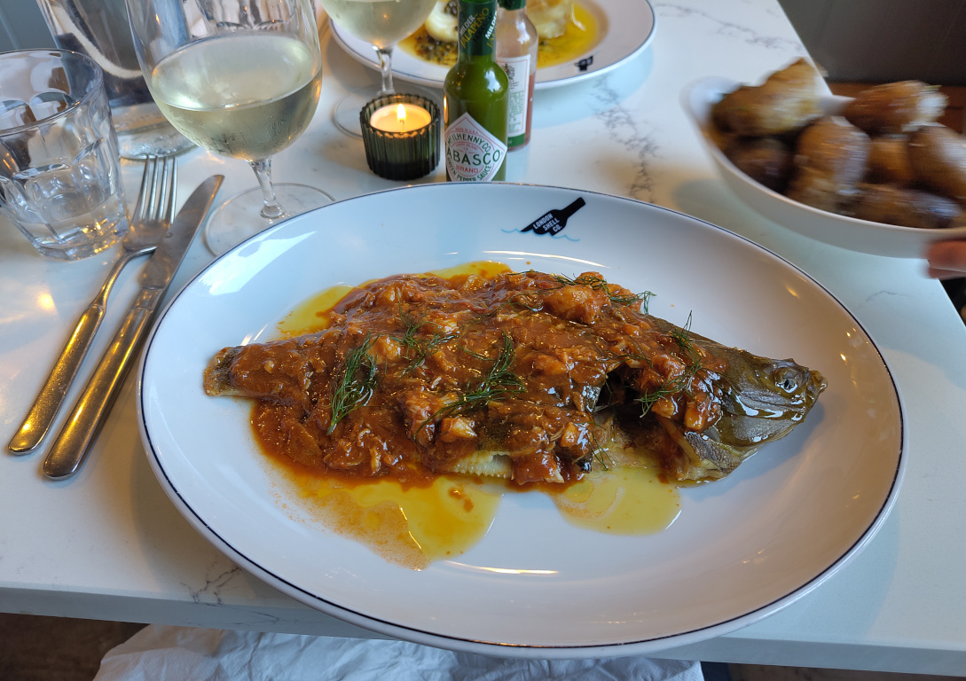 A whole plaice with lobster sauce.
